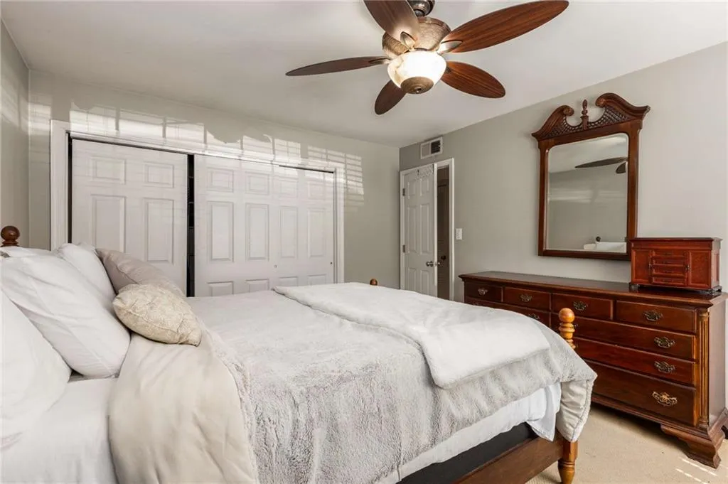 Bedroom featuring a triple door closet