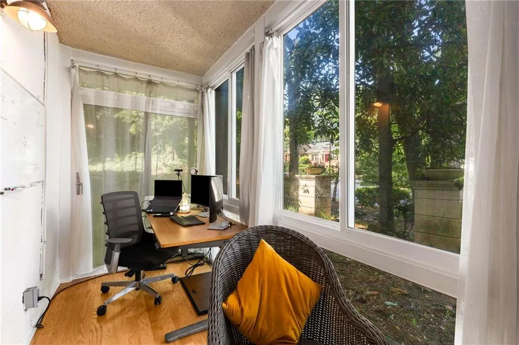 Sun room  currently used as office has exterior door behind desk.