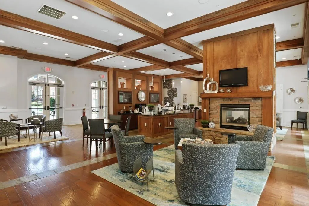 Living room with coffered ceiling, hardwood / wood-style floors, french doors, a fireplace, and beam ceiling