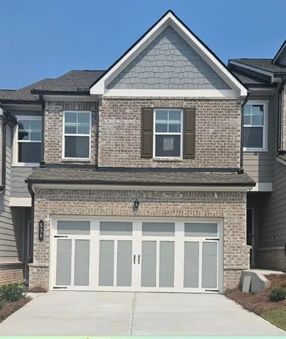 Brick and shingle exterior with a prominent gabled roofline