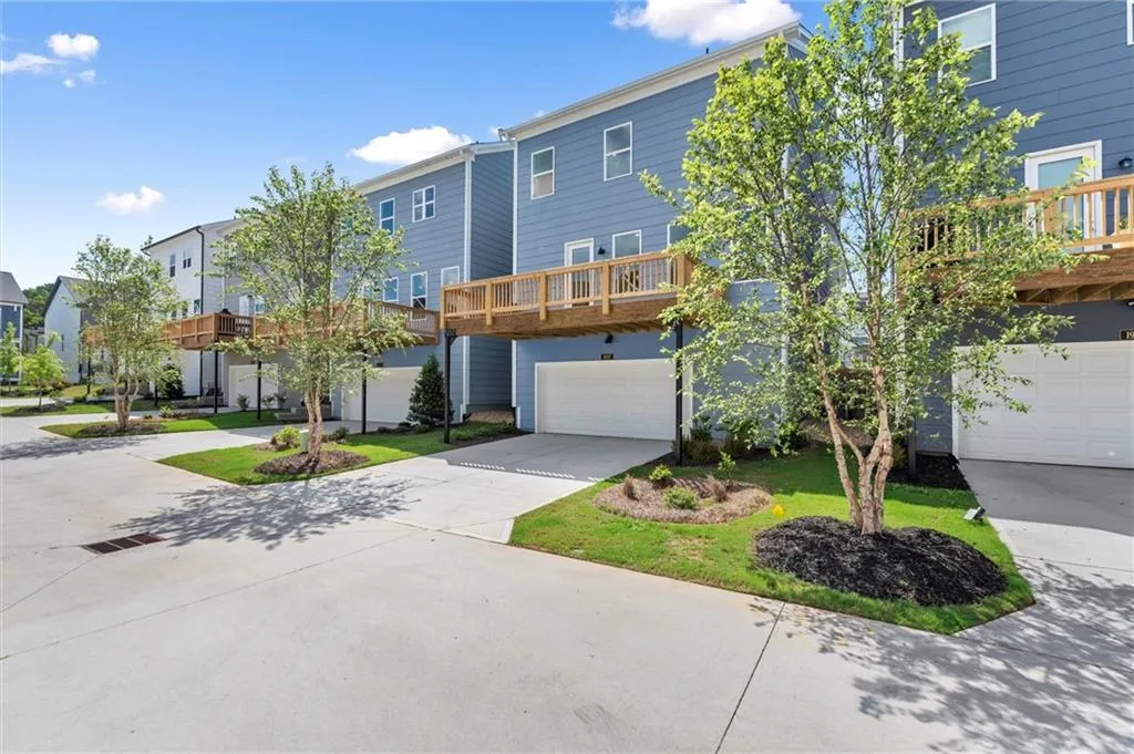 View of front of house with an attached garage, driveway, and a residential view