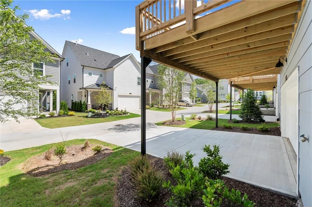 View of patio / terrace with a garage, a residential view, and driveway
