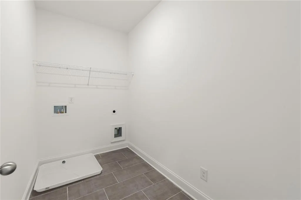 Laundry room featuring baseboards, electric dryer hookup, and washer hookup