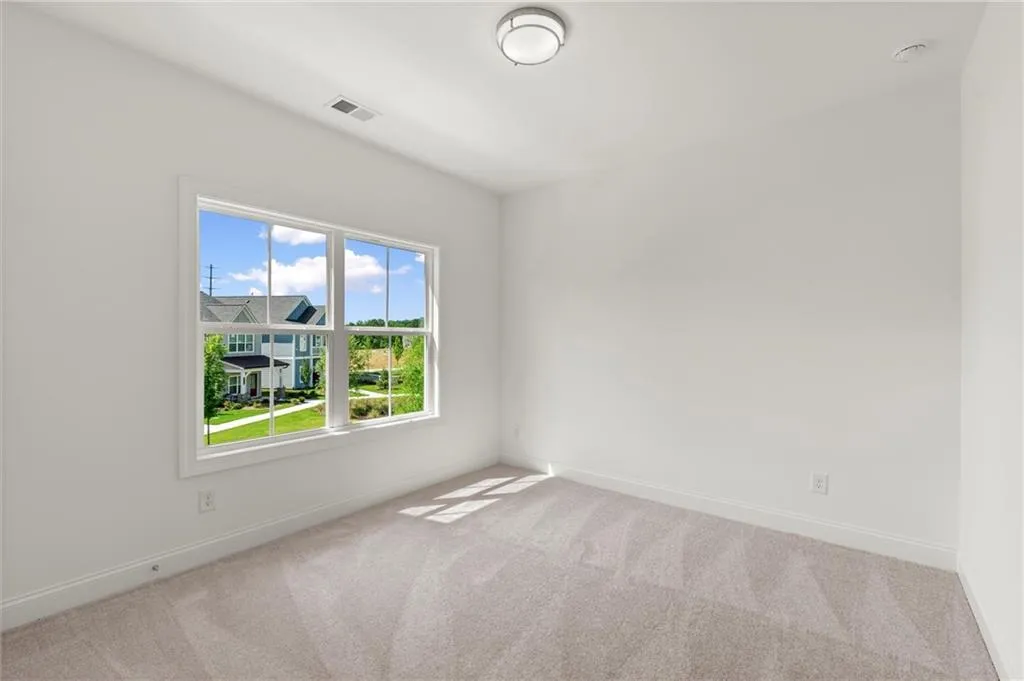 Carpeted spare room with baseboards