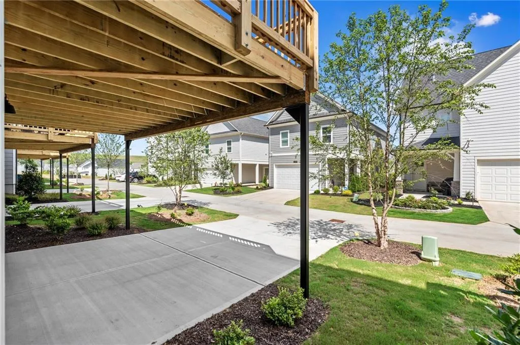 View of patio / terrace featuring an attached garage and concrete driveway