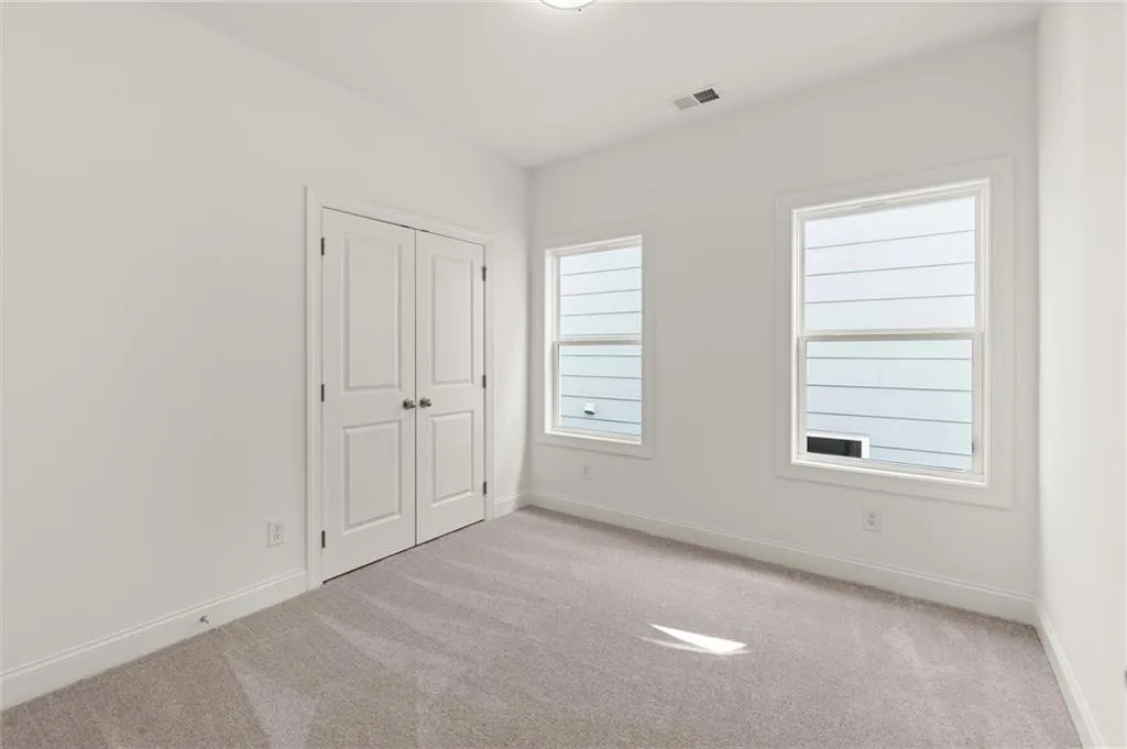 Unfurnished bedroom with carpet floors, baseboards, and a closet