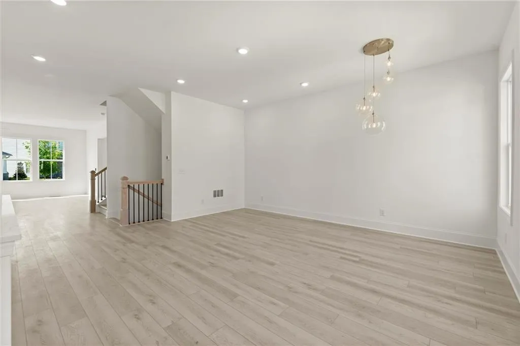 Unfurnished room with light wood-type flooring, baseboards, and recessed lighting