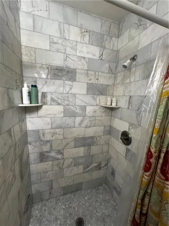 Full bathroom with a shower stall