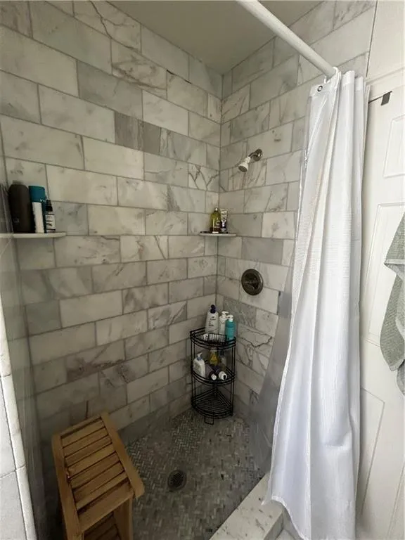 Full bathroom with a shower stall