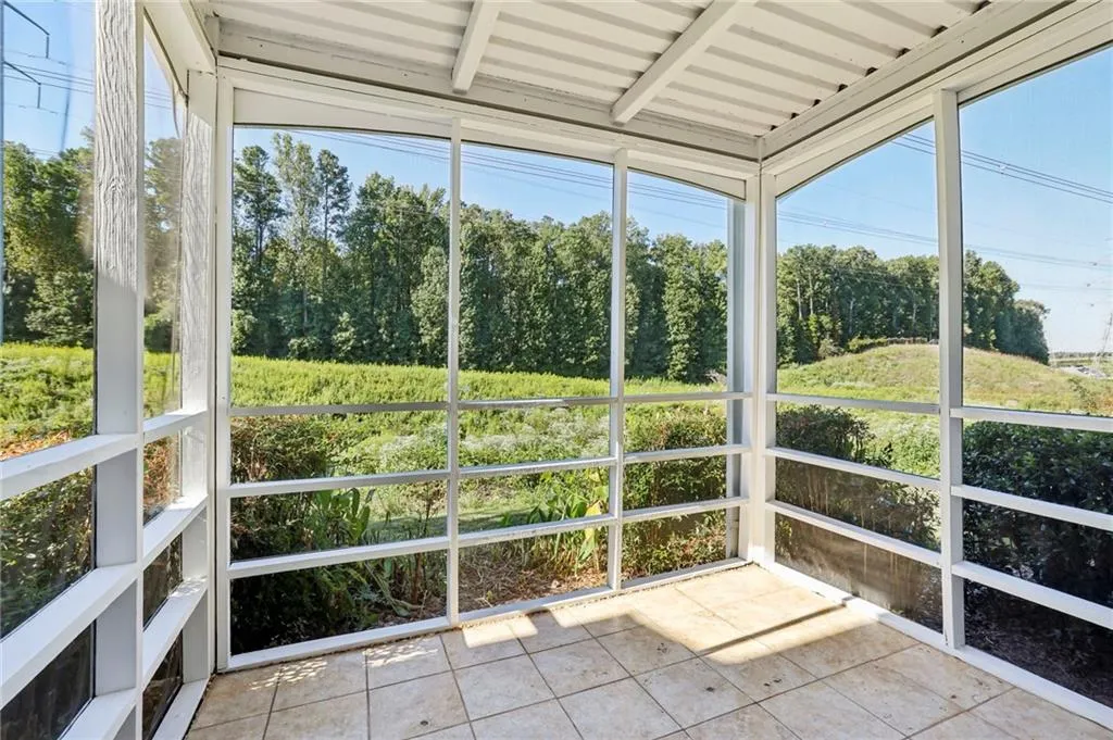 View of sunroom with new screens and freshly painted open to view of nature