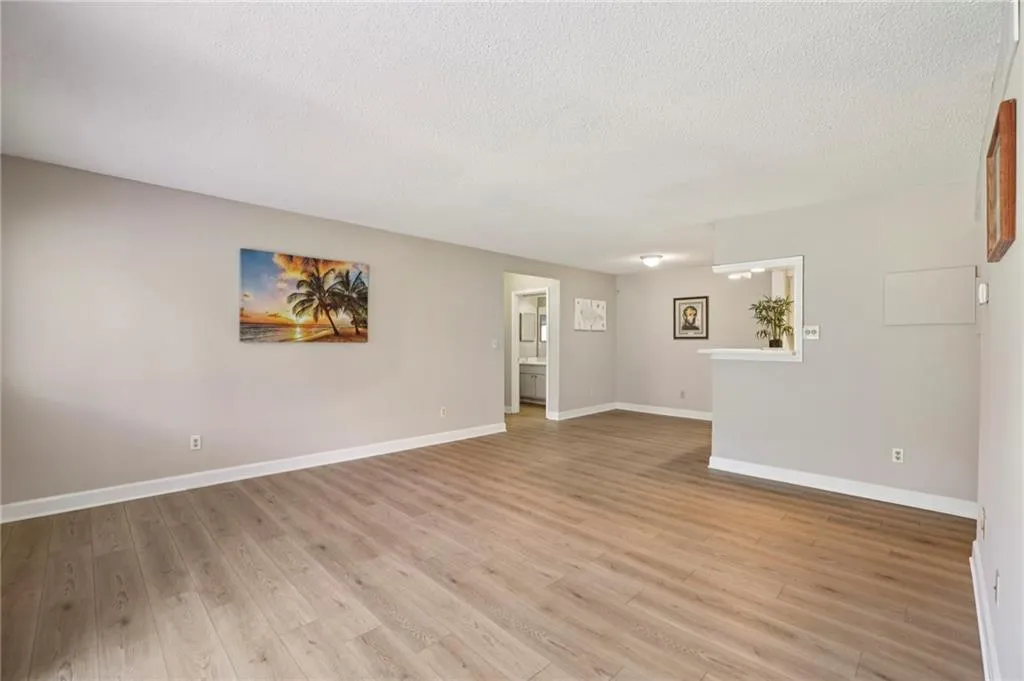 Unfurnished room featuring light wood finished floors and a textured ceiling