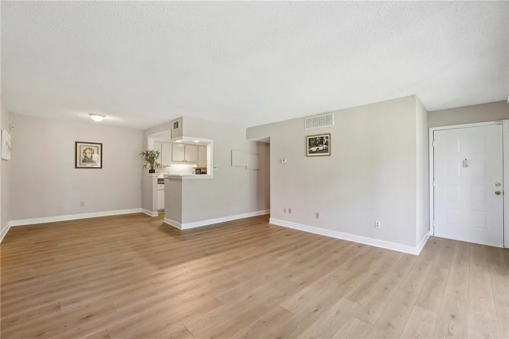Unfurnished living room featuring light wood finished floors and a textured ceiling