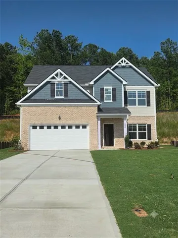 Two-story residence featuring a brick first story and siding on the second story