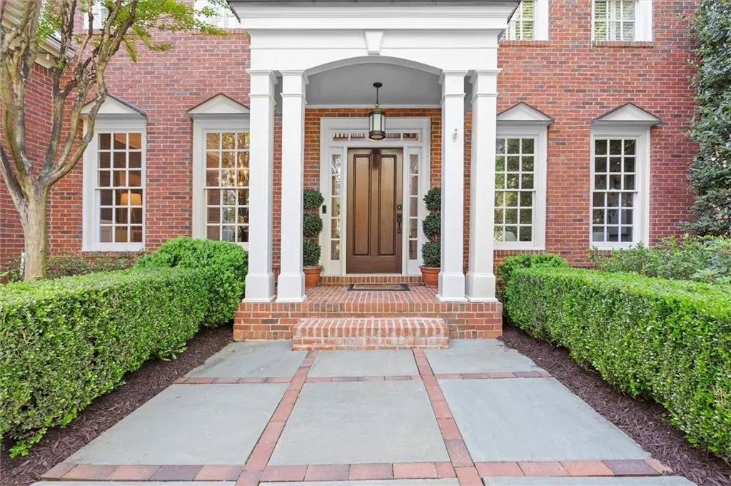 Property entrance featuring brick siding