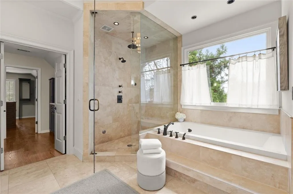 Full bathroom featuring a garden tub, a stall shower, tile patterned flooring, and healthy amount of natural light