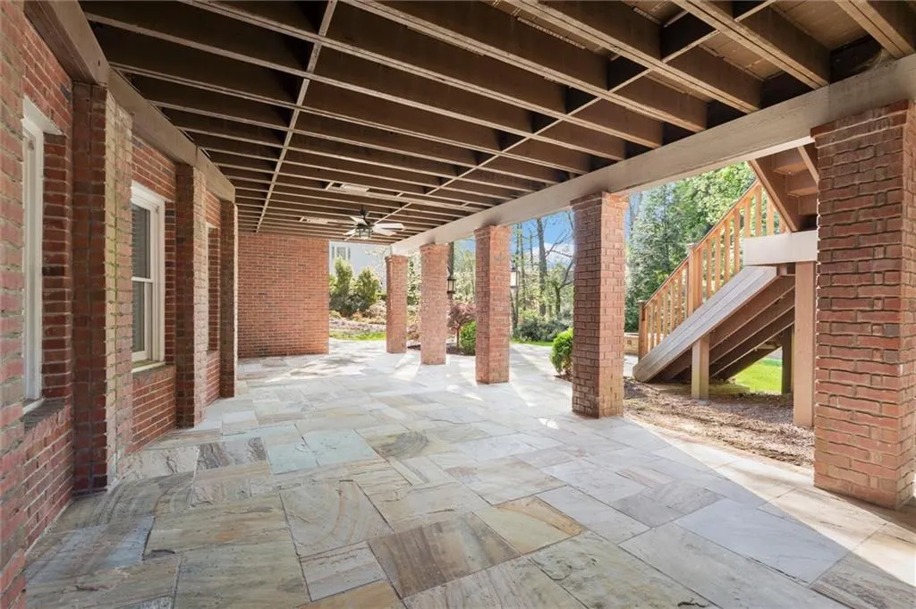 View of patio featuring stairs and ceiling fan