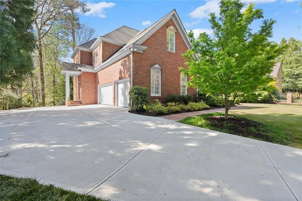 View of side of home with brick siding and driveway
