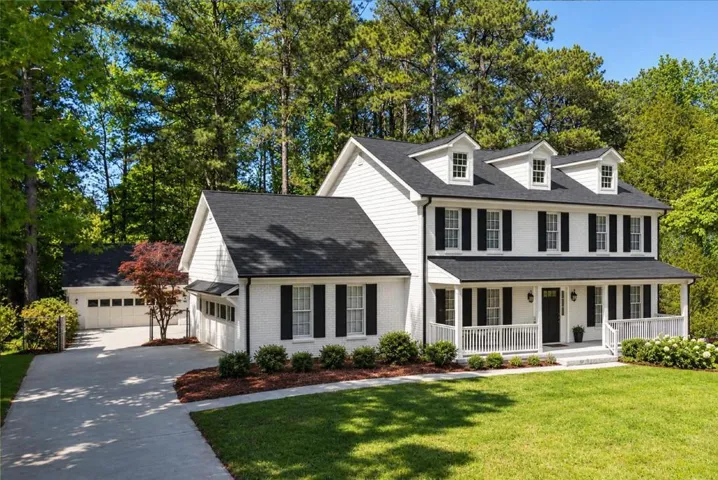 Two-story white exterior with black shutters