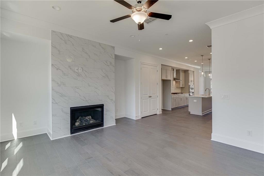 The family room has upgrade can lighting, niches to left and right of fireplace and overhead fan.