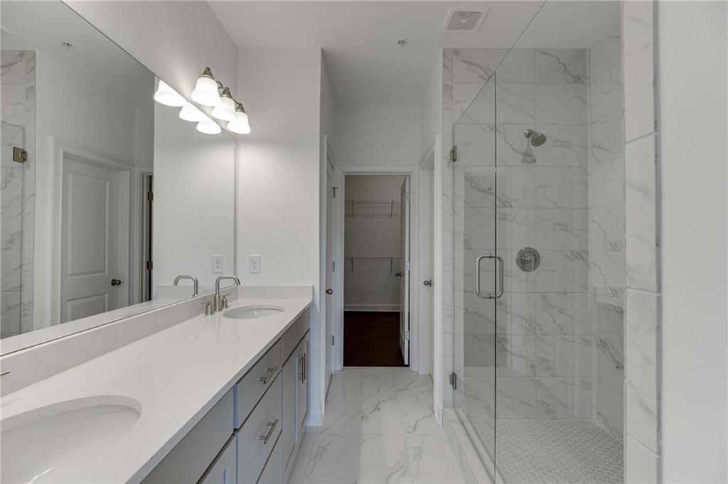 The primary bath has double vanities and a spa like shower!