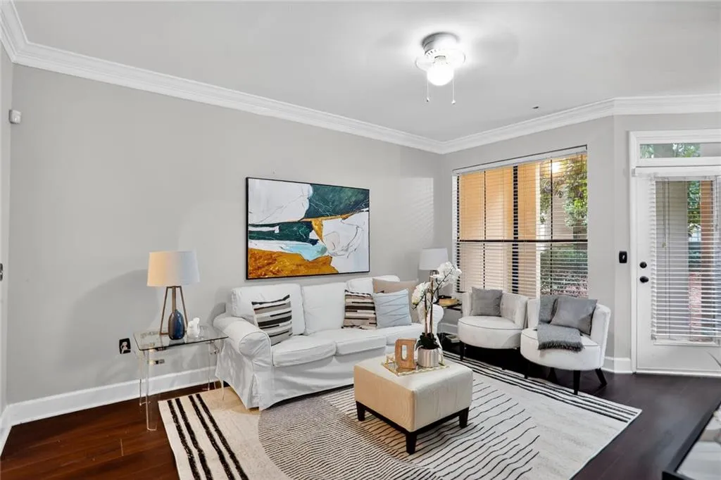 Living room featuring crown molding and wood finished floors