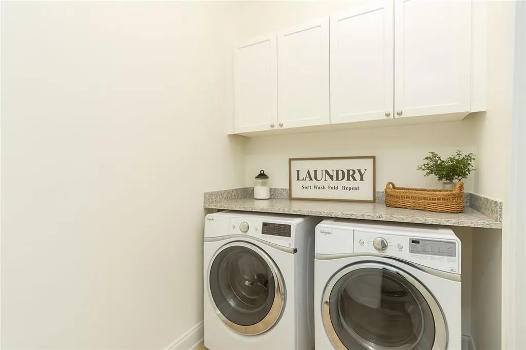 THIS PHOTO HAS BEEN VIRTUALLY STAGED. Laundry room on upper level.