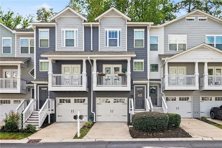 Multi-level townhome with a two-tone facade and multiple balconies