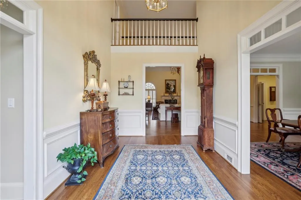 Two story foyer is flanked by sepaarate living room & dining room