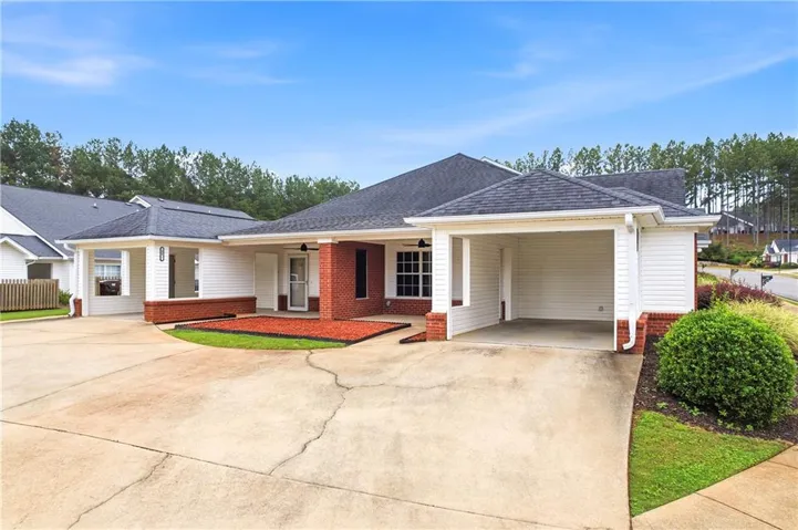 Single-story residence featuring white siding and red brick accents