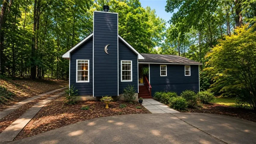 Dark blue siding exterior with white trim windows