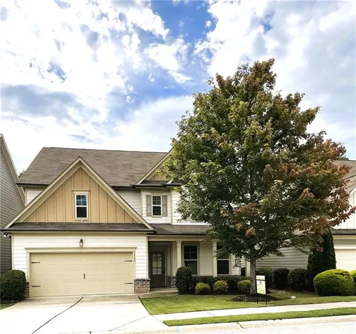 Two-story exterior with a two-car garage, multiple gables, and a prominent front entrance