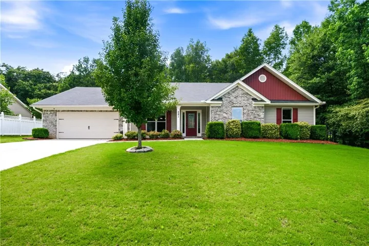 Traditional single-story residence with a stone accent facade and red gables