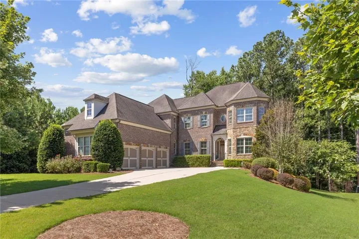 Brick exterior with stone accents and a multi-gabled roofline