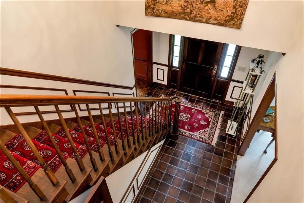 Stairs featuring a high ceiling and tile flooring