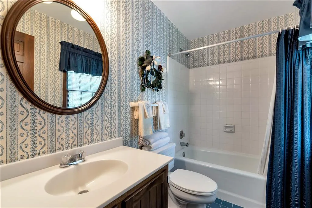 Large Ensuite Full Bathroom with tile surround and flooring