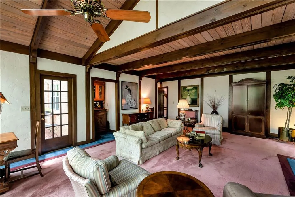Second view of family room with wood beams and shiplap wood ceiling.