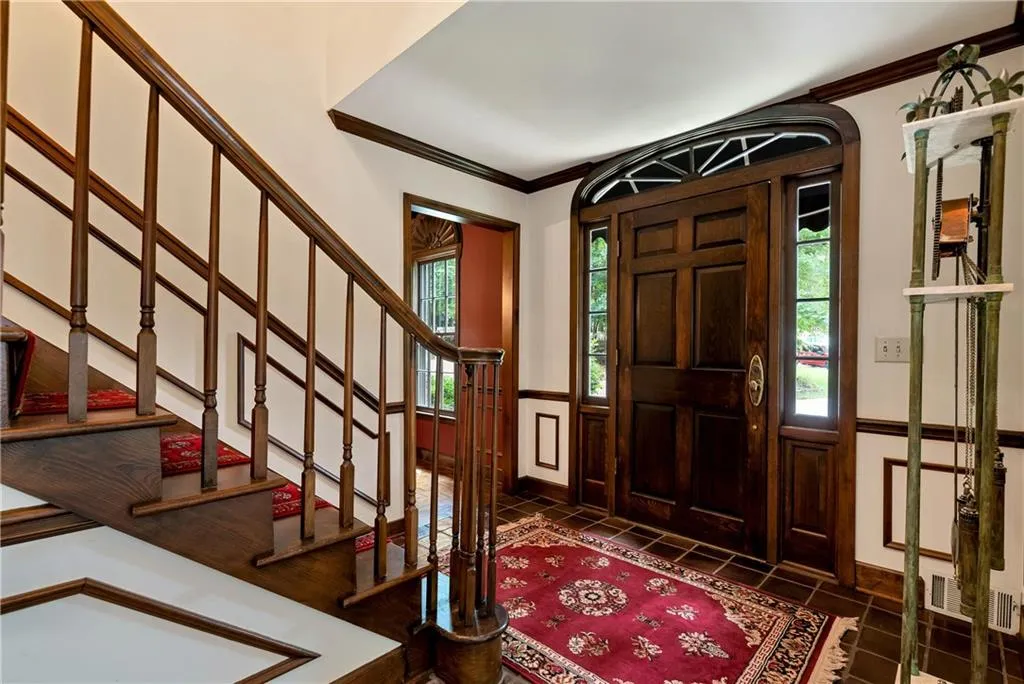 Entryway with ornamental molding and tile floors