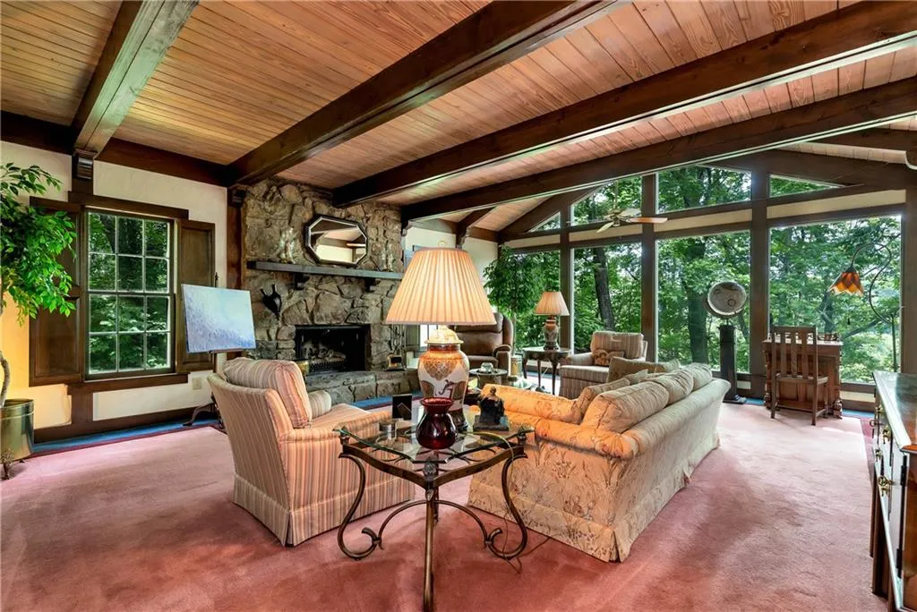 Family Room with wooden ceiling, lofted ceiling with beams, and a fireplace