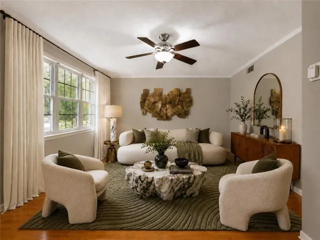 VIRTUALLY STAGED - Spacious room featuring wood-finish flooring, a ceiling fan with integrated lighting, and crown molding