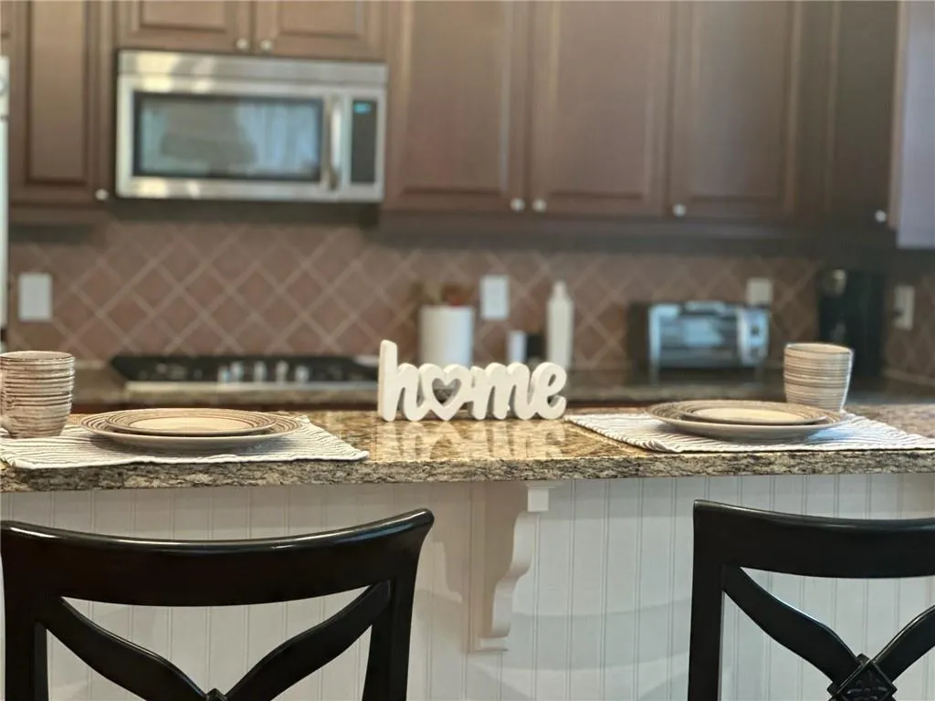 Kitchen featuring stone counters