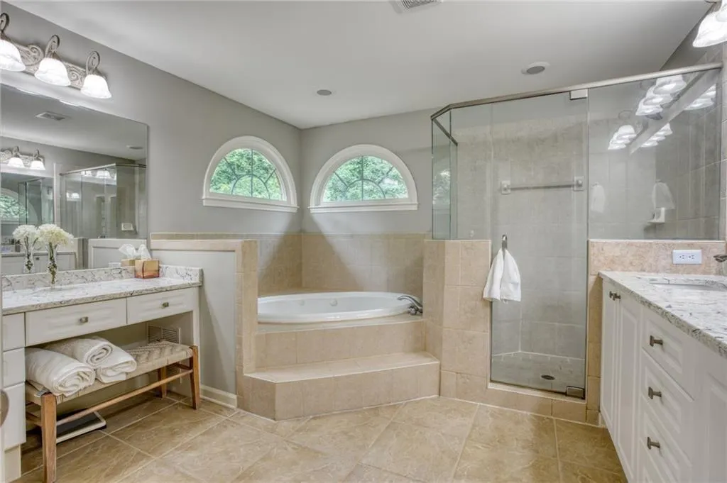Bathroom with plus walk in shower, tile patterned flooring, and vanity