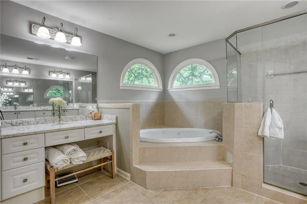 Large Master Bathroom featuring vanity, separate shower and tub, and tile patterned floors
