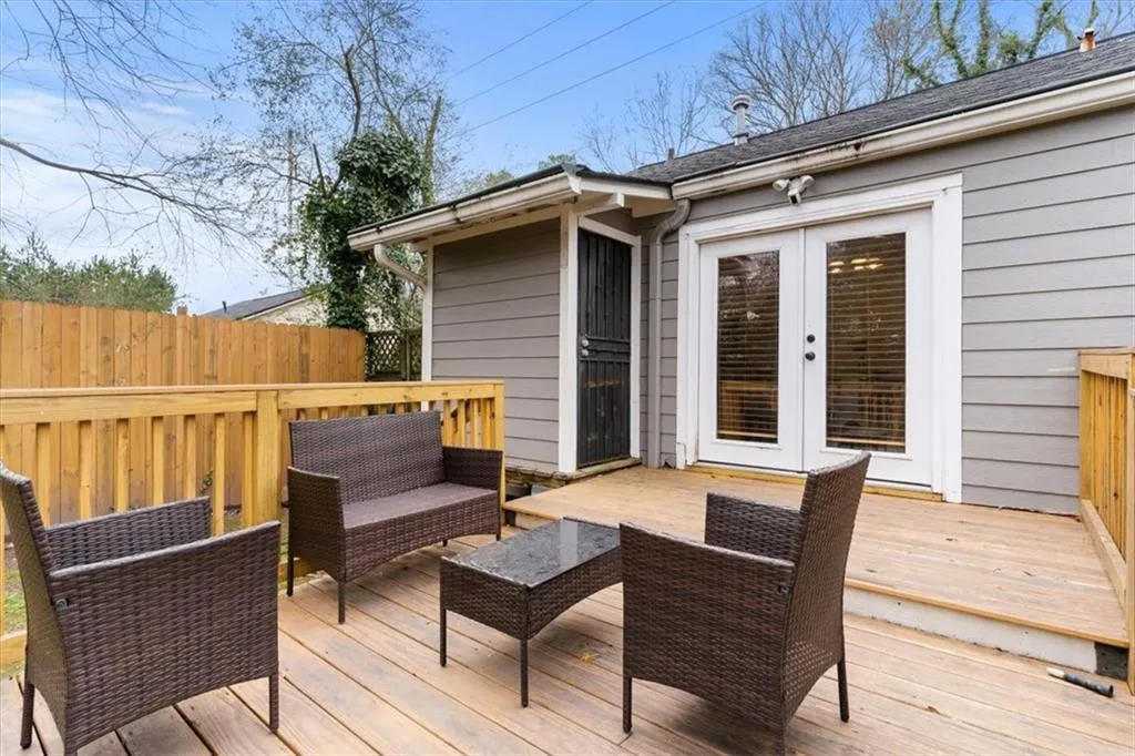 Wooden deck with french doors and an outdoor hangout area
