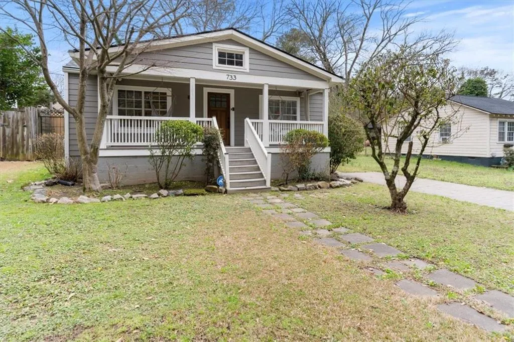 View of front of home with a porch and stairway