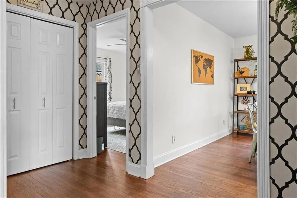 Hallway featuring wood finished floors and baseboards
