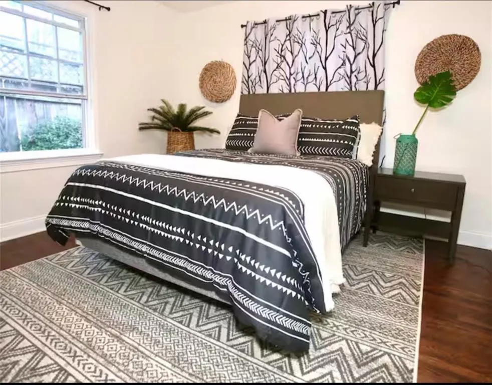 Bedroom with baseboards and wood finished floors