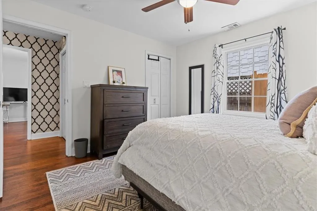 Bedroom featuring wood finished floors, ceiling fan, and a closet