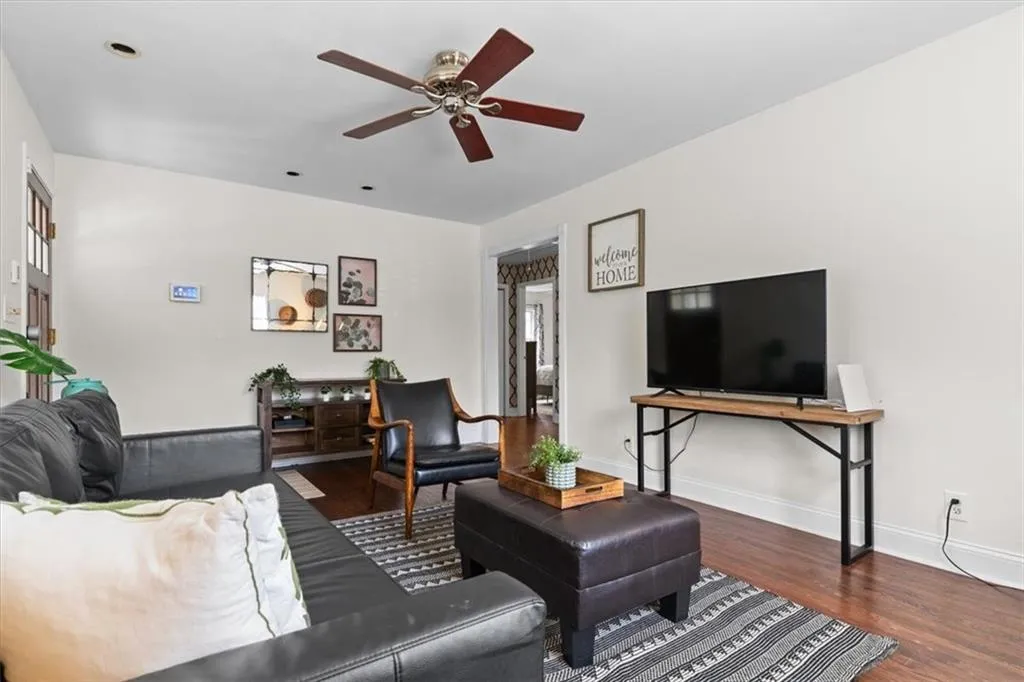 Living room featuring wood finished floors and a ceiling fan