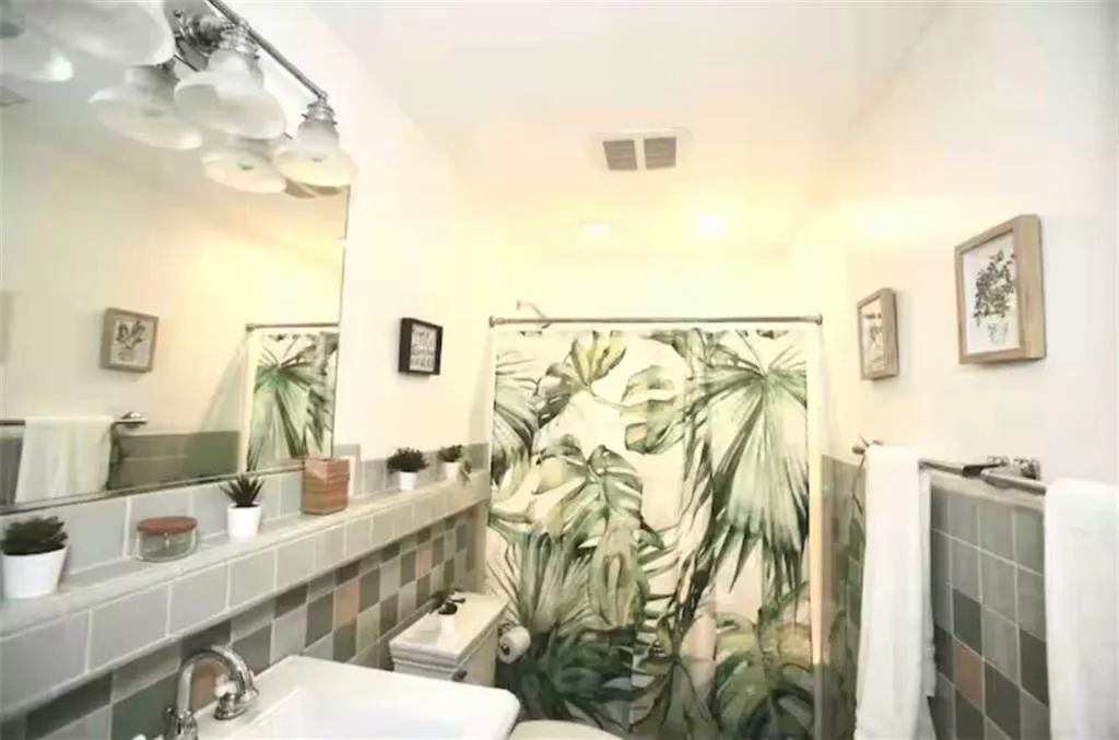 Bathroom featuring tile walls and  tub shower combo