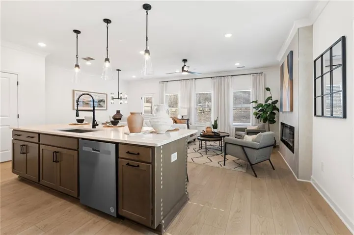 Spacious kitchen island with light-toned countertop and integrated sink